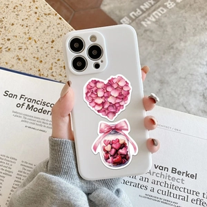 Detail of pink heart stickers on white phone case with romantic floral and jar designs