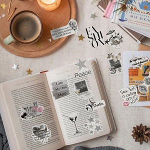 Y2K style silver stickers with disco ball and butterfly motifs on a cozy desk setup
