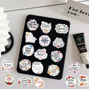 Detailed view of Spanish biblical quote stickers applied on a black tablet surface