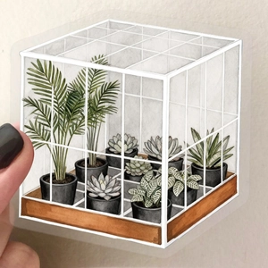 Close-up of a clear PET greenhouse sticker with watercolor plants on a laptop surface