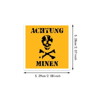 Close-up of a yellow hazard sticker featuring a skull icon and German warning text