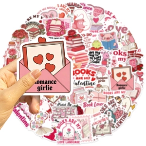 Detailed view of pink romance book lover stickers held by hand for journal decorating