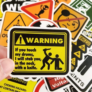 Detail shot of waterproof vinyl warning stickers for luggage and laptop decoration