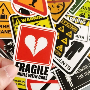 Waterproof vinyl warning stickers showing various caution signs on durable adhesive decals