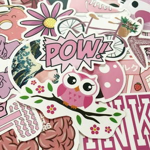 Close-up of pink cute cartoon stickers for suitcases and laptops with diverse patterns