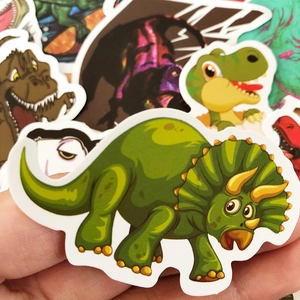 Close-up of waterproof cartoon dinosaur stickers with white die-cut edges for kids