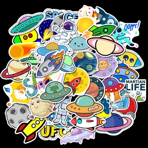 Close-up of space-themed stickers featuring astronauts, rockets and planets on black backdrop