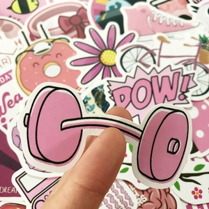 Close-up of pink waterproof cartoon stickers featuring dumbbell and donut designs