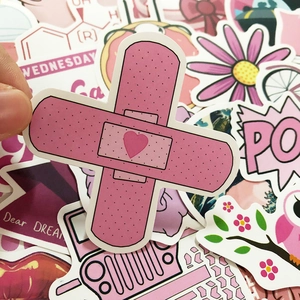 Close-up of pink heart bandage stickers with matte finish for laptops and luggage