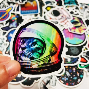 Close-up of a holographic astronaut cat sticker with space theme designs for laptops