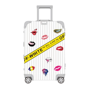 White striped suitcase featuring sexy lip stickers and yellow industrial brand straps