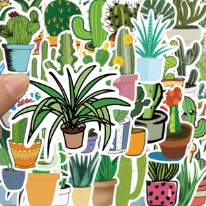 Close-up of hand holding a cartoon cactus sticker from a bulk decorative plant set
