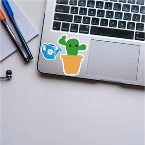 Waterproof cactus sticker and blue watering can decal on a silver laptop surface