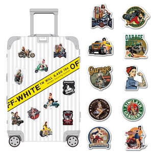 Detail of vintage motorcycle pin-up stickers applied on a white travel suitcase