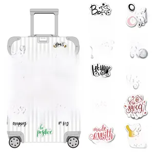 Close-up of inspirational English quote stickers on a white textured suitcase and luggage