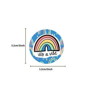 Detail view of a 2-inch waterproof sticker featuring a rainbow and 'it's a vibe' slogan