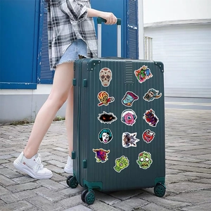 Waterproof skull and monster graffiti stickers applied on dark green travel suitcase