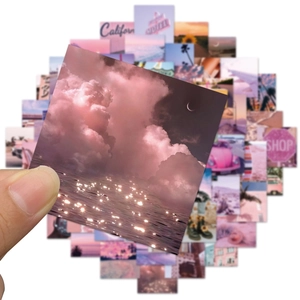 Detailed view of pink California sun stickers featuring clouds and palm trees for laptops