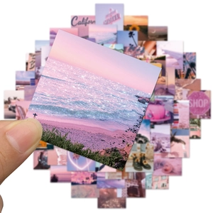 Close-up of pink California aesthetic stickers featuring sunset landscapes and palm trees