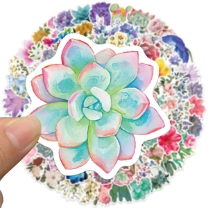 Close-up of hand holding a waterproof watercolor succulent sticker among a floral sticker set