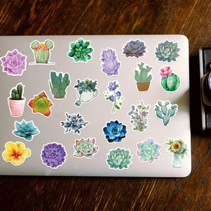 Close-up of waterproof succulent stickers applied on a silver laptop surface