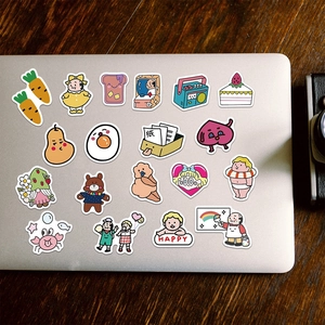 Close-up of cute cartoon stickers on a laptop lid featuring various colorful hand-drawn patterns