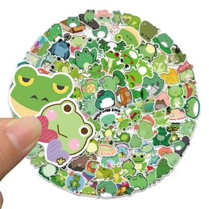 Detailed view of waterproof green frog cartoon stickers being held to show size and scale