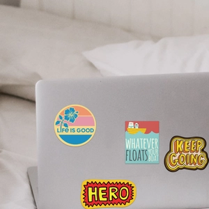 Set of 100 colorful motivational waterproof vinyl stickers on a laptop surface