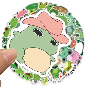 Close-up of waterproof cartoon frog stickers for laptops and luggage decor