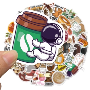Close-up of waterproof PVC coffee astronaut stickers being held for laptop decor