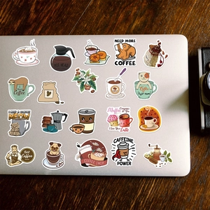 Detail of coffee theme cartoon stickers featuring cats and sloths on a laptop cover
