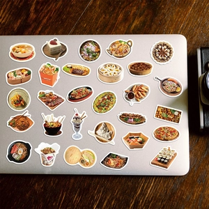 Waterproof food menu stickers applied to a laptop lid on a wooden desk background