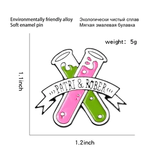 Detail view of test tube enamel pin with pink and green liquids and dimension markings