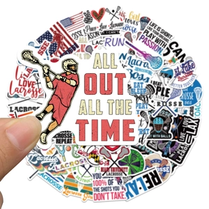 Close-up showing a hand holding a waterproof lacrosse sports sticker for luggage and laptop