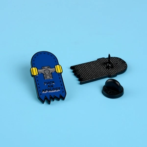 Cartoon skateboard enamel pin featuring black text with yellow wheels and rubber back