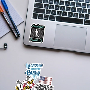 Detail of Lacrosse stickers featuring silhouettes and flags on a laptop surface