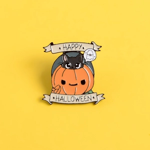 Enamel Halloween brooch featuring a black cat in a pumpkin with Happy Halloween banners