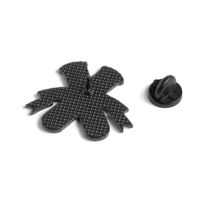 Detail view of enamel pin back with textured metal finish and black rubber clutch accessory