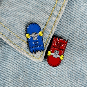 Street style enamel skateboard pins with rebel quotes on light blue denim fabric