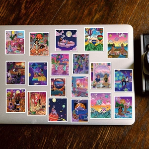 Set of 50 aesthetic cartoon stickers on silver laptop over dark brown wood desk