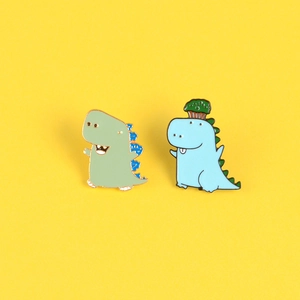 Set di spille smaltate a forma di simpatici dinosauri a fumetti in verde e blu