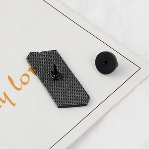 Detail view of the enamel pin back with black honeycomb texture and rubber clutch