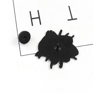 Detail view of the black rubber clutch and needle backing on the enamel pin