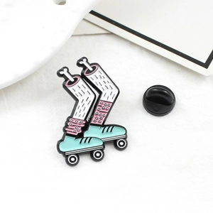 Unique roller skate brooch with pink polka dot socks and enamel finish on white background