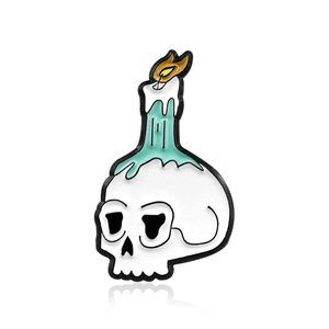 Gothic skull enamel brooch with burning candle and teal dripping wax detail