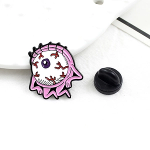 Quirky alien eyeball enamel pin with red bloodshot details and a black rubber clutch