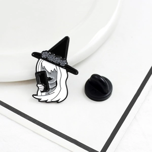 Enamel brooch of a white-haired girl in a witch hat taking a selfie on a white plate