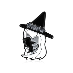 Artistic enamel brooch featuring a long-haired girl in a black wizard hat and floral decor