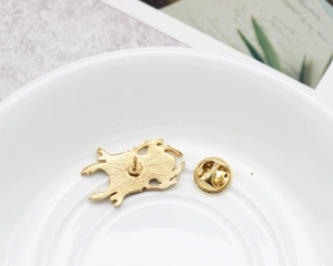 Detail view of beetle brooch back with pin closure and butterfly clutch gold plating