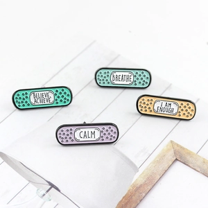 Set of four colorful bandage enamel pins with inspirational quotes on creative background